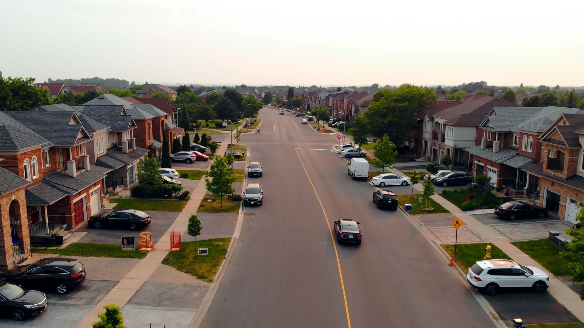 Road traverses scenic US suburb, a picturesque setting for road enthusiasts. Ideal for showcasing road life in tranquil neighborhoods, capturing the essence of suburban road in peaceful environments.